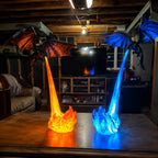 Fire and Ice Dragon's Breath lamps lit side by side on a wooden table